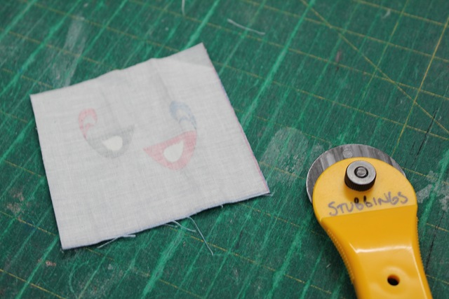 a piece of fabric and rotary cutter  - from A Quick and Simple Needlebook Tutorial by Helen of Hugs 'n Kisses