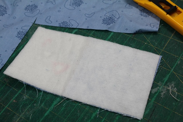 a white, rectangular piece of fabric - from A Quick and Simple Needlebook Tutorial by Helen of Hugs 'n Kisses