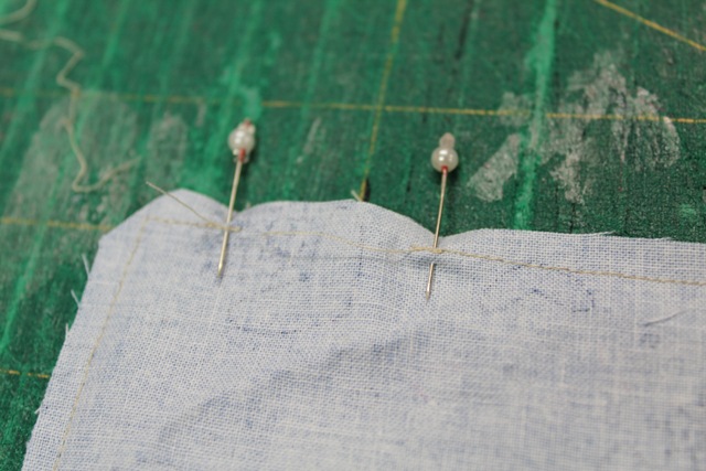 a close up shot of a piece of fabric with dressmaking pins - from A Quick and Simple Needlebook Tutorial by Helen of Hugs 'n Kisses